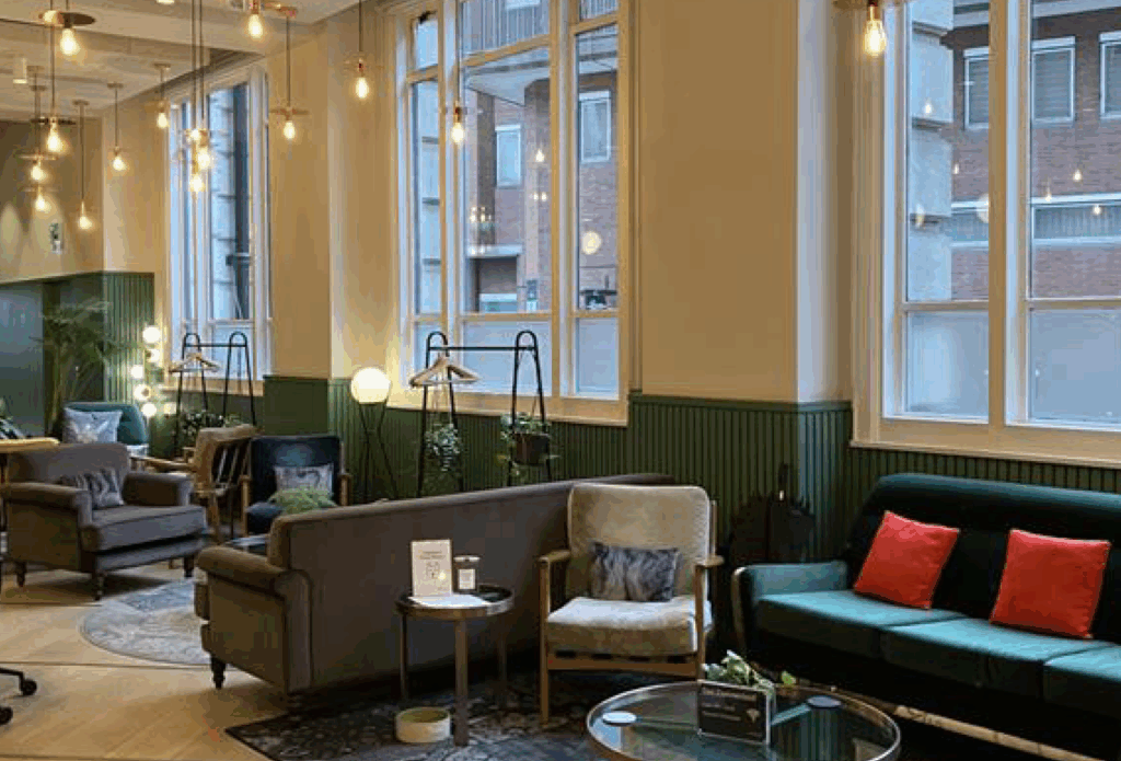 Image of a lounge area with lots of sofas, chairs, and tables.