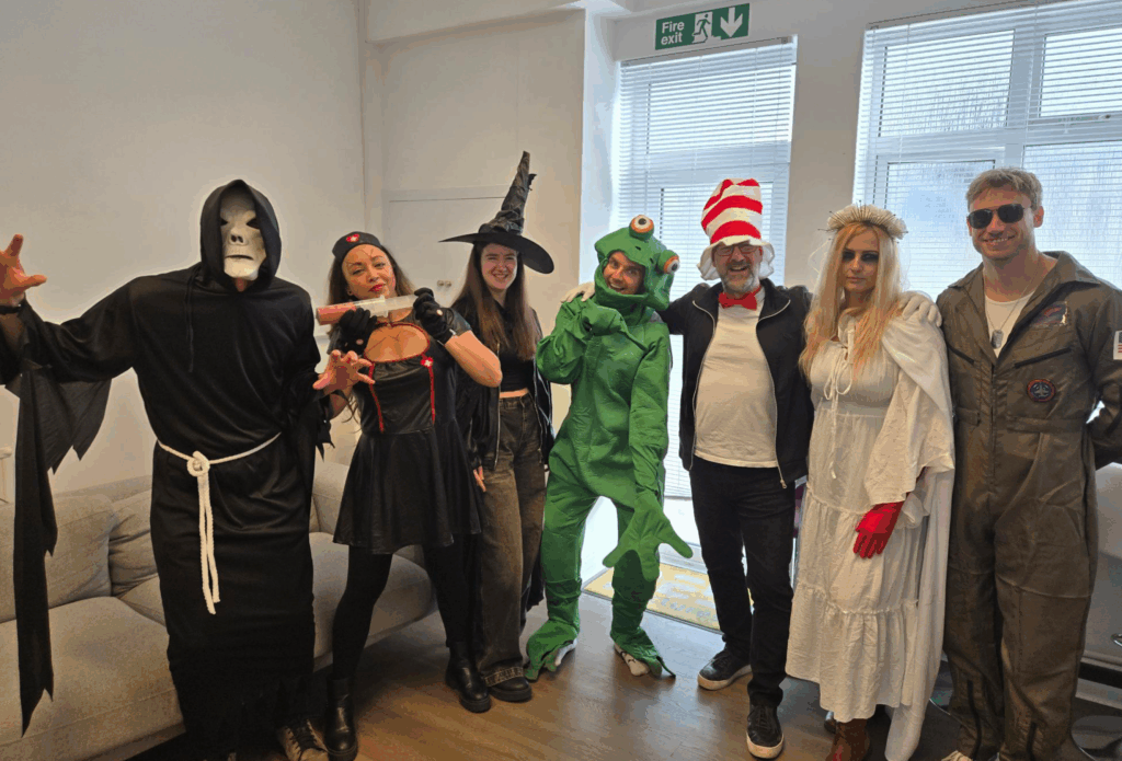 A picture of 3 women and 4 men dressed up in various Halloween costumes.